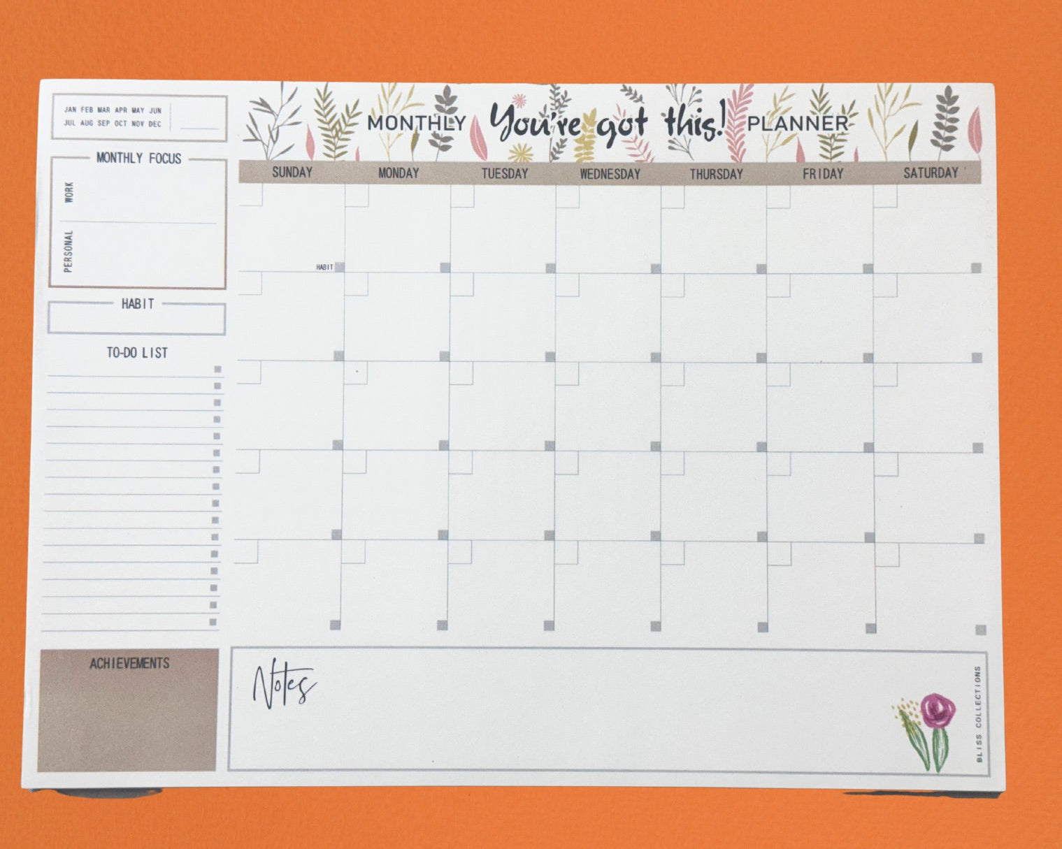 Planner with grid layout and decorative elements on an orange background